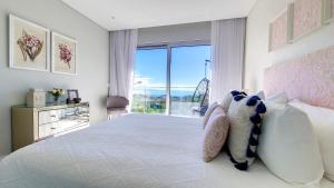 a bedroom with a bed and a large window at 24, The Townhouse by LovelyStay in Funchal +36 photos