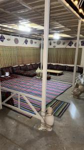 a room with a large rug on the floor at Discovery Camp Bidiya in Badīyah