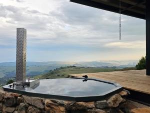 a bath tub sitting on top of a mountain at Eagle View on Beumont in Dullstroom
