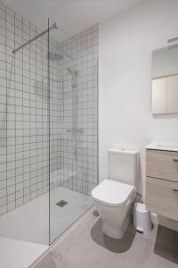 a bathroom with a toilet and a glass shower at Coqueto apartamento muy centrico in Vigo