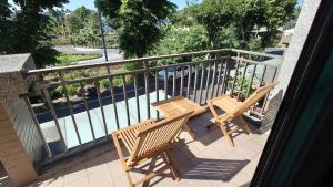 two wooden benches sitting on a balcony at Bestime B&B in Jiji