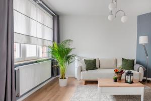 a living room with a couch and a table at Evere EU Residence in Brussels