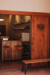a coffee store with two stools and a bench at Cozy Room at The Coffee Store Charoenkrung in Bangkok