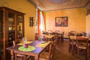a restaurant with wooden tables and chairs in a room at Locanda di CasalMustia in Castelmuzio
