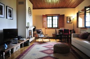 a living room with a couch and a table at Villa 282 in Calheiros