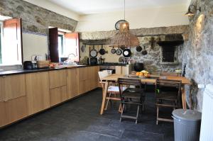 a kitchen with a table and chairs in a room at Villa 282 in Calheiros