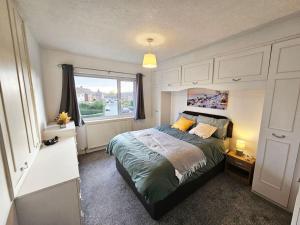 a bedroom with a bed and a large window at Little Hulton, Manchester 