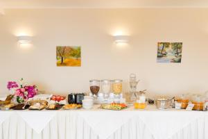 a white table with a buffet of food on it at Costa Smeralda in Sivota