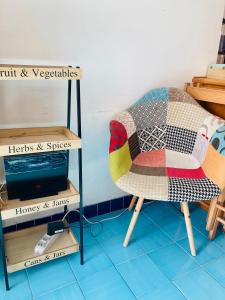 a chair with a quilt on it in a room at La Perla di Posillipo in Naples