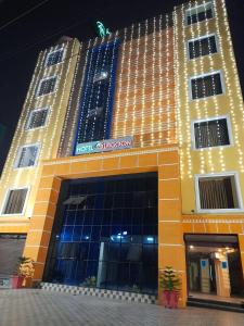 a hotel building with a sign on the front of it at Hotel AS Lagoon in Bhubaneshwar