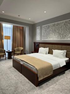 a bedroom with a large bed in a room at Mir Luxe Plaza in Tashkent