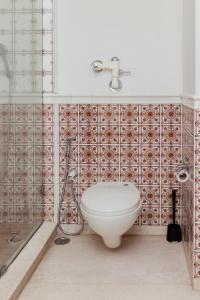 a bathroom with a toilet and a shower at Luho 41 Penthouse in Bangalore +45 photos