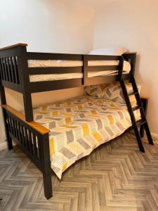a bunk bed in a room with a wooden floor at The Red Door Holiday Let Limavady in Limavady