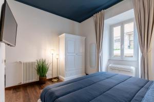 a bedroom with a blue bed and a window at Suite Vaticano in Rome