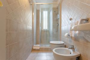 a bathroom with a shower and a toilet and a sink at Suite Vaticano in Rome