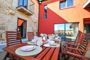 a wooden table with plates of food on a patio at Villa 278 in Varziela