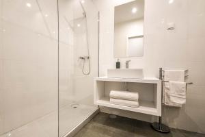 a white bathroom with a sink and a shower at Villa 278 in Varziela +15 photos