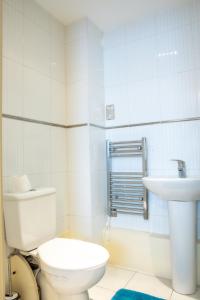 a white bathroom with a toilet and a sink at Newly furnished Appartment near Train Station wolverhampton in Wolverhampton