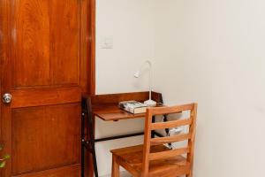 a desk with a lamp on it next to a door at Luho 41 Penthouse in Bengaluru