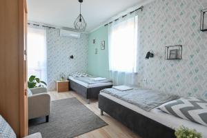 Posteľ alebo postele v izbe v ubytovaní BellaVista 2 Apartman