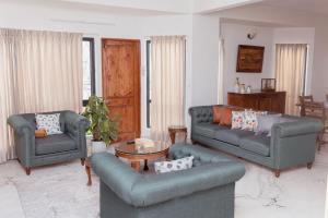 班加羅爾的住宿－Luho 41 Penthouse，客厅配有两张沙发和一张桌子