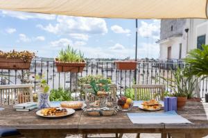 una mesa con platos de comida en el balcón en B&B Iris en Laterza