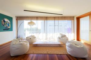 a living room with white furniture and a large window at HM - Ocean Breeze Delight in Matosinhos