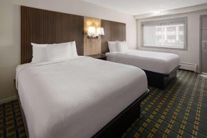 A bed or beds in a room at Days Inn by Wyndham Tonawanda/Buffalo