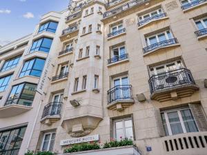 a building with balconies on the side of it at Mercure Paris Opéra Faubourg Montmartre in Paris