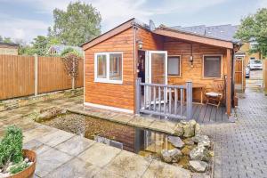 a tiny house with a pond in a yard at Host & Stay - Astoria in Broadstairs