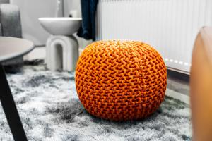 an orange ball sitting on the floor in a room at The Town Haus By Homebay in Northampton