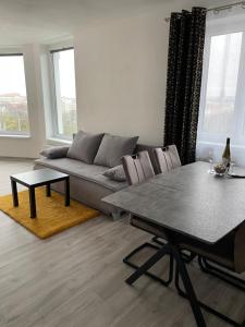 a living room with a couch and a table at Sky Apartments 506 in Plzeň