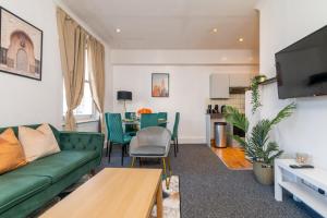 sala de estar con sofá verde y mesa en LiveStay - Apartments in Bayswater London, en Londres