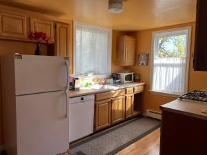 a kitchen with a white refrigerator and a sink at Beautiful Townhouse, 2 bedrooms, 2 bath in Boston