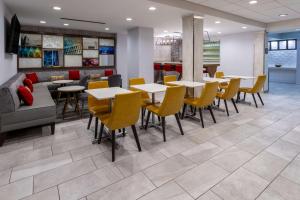 a restaurant with tables and chairs and a couch at Hampton Inn Atlanta-Georgia Tech-Downtown in Atlanta