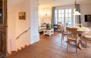 cocina y sala de estar con mesa y sillas en LH Isernhagenhof, App 1, en Wenningstedt