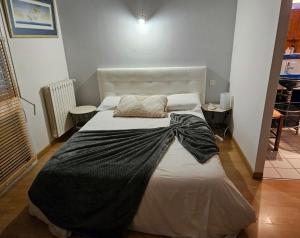 a bedroom with a bed with a black blanket on it at Villa Mars YourHostHelper in Narbonne