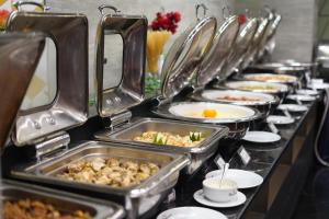a row of trays of food on a buffet line at The Zabeer Dhaka in Dhaka