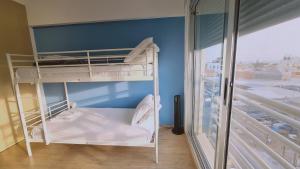 een slaapkamer met 2 stapelbedden en een balkon bij STAY Mystique City Penthouse in Limassol