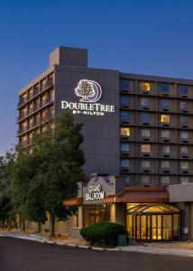 a hotel building with a sign that reads the dole tree hotel at DoubleTree by Hilton Hotel Denver in Denver