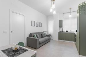 a living room with a couch and a kitchen at Apartment Milan San Siro City Life & Fiera in Milan