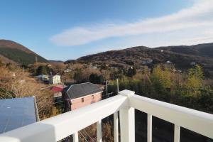 a view of the mountains from the balcony of a house at 【芦ノ湖徒歩10分＆バス停1分】一棟貸切最大14人 大人數BBQ可能 パーティ 『ROUTE99』 in Moto-hakone