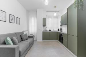 a living room with a couch and a kitchen at Apartment Milan San Siro City Life & Fiera in Milan