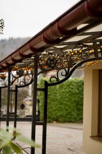a wrought iron fence with lights on it at Петрос Family Hotel in Yaremche