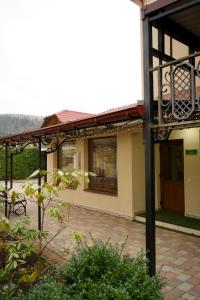 an outside view of a house with a patio at Петрос Family Hotel in Yaremche