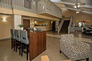 a lobby with a bar with chairs and a staircase at Quality Inn near Medical Center in Rochester