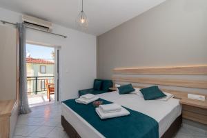 a bedroom with a bed and a balcony at Gramatiki House in Neos Marmaras