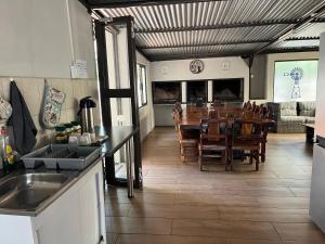 a kitchen and dining room with a table and chairs at La Belle Guesthouse Parys in Parys
