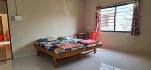 małe łóżko w pokoju z oknem w obiekcie Galaxy Residency w mieście Aurangabad