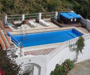 a swimming pool on the side of a house at The Vine Studio in Rubite